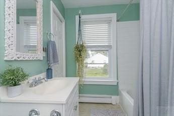 bathroom featuring vanity and baseboard heating