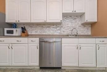 kitchen featuring white cabinetry, backsplash, dishwasher, and white microwave