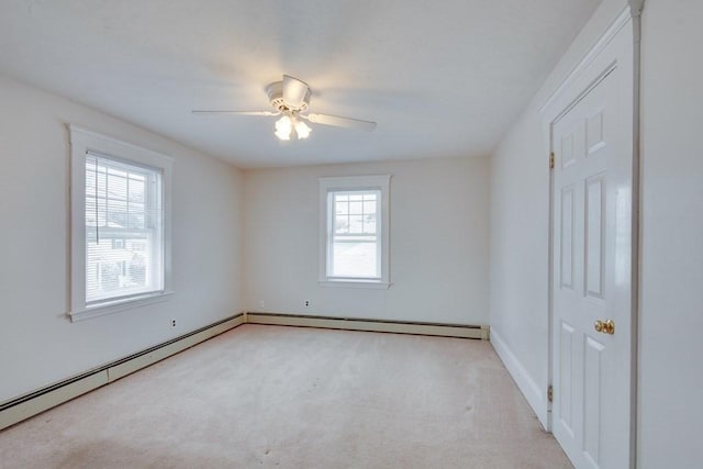 empty room featuring carpet flooring, a ceiling fan, baseboards, and baseboard heating