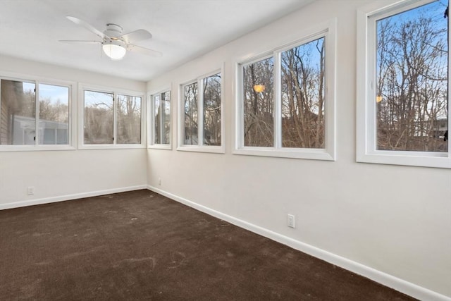 unfurnished sunroom with plenty of natural light and ceiling fan