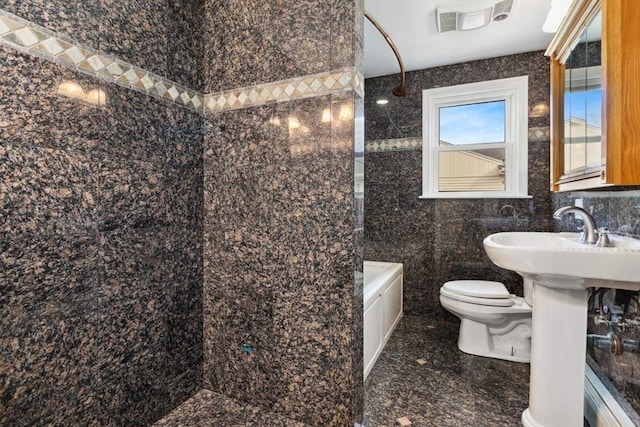 full bathroom with tiled shower / bath, sink, tile walls, and toilet