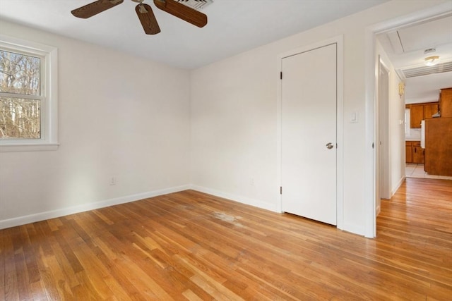 empty room with ceiling fan and light wood-type flooring