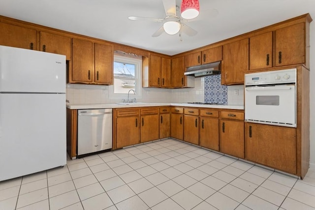 kitchen featuring tasteful backsplash, sink, white appliances, and ceiling fan