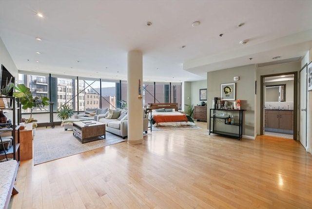 interior space with light wood-type flooring and floor to ceiling windows