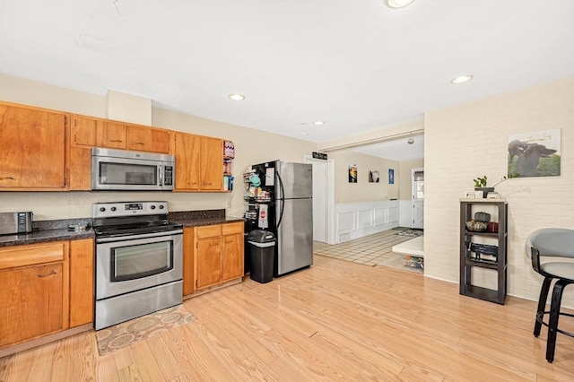 kitchen featuring stainless steel appliances and light hardwood / wood-style floors