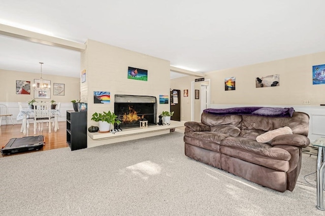 living room with hardwood / wood-style flooring and an inviting chandelier