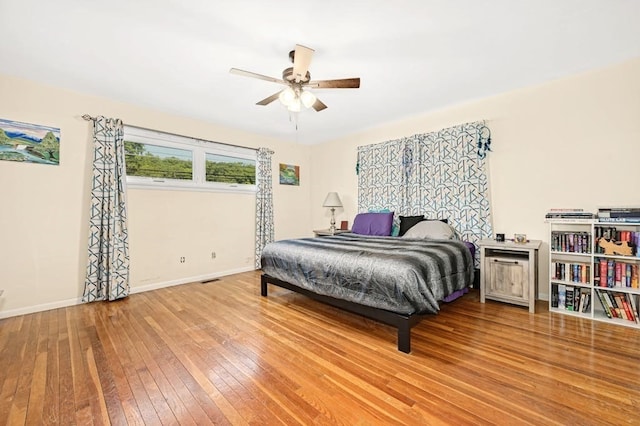 bedroom with ceiling fan and hardwood / wood-style floors