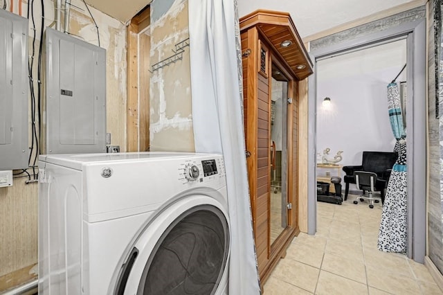 clothes washing area with washer / clothes dryer, electric panel, and light tile patterned floors