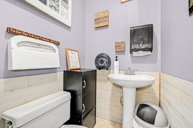 bathroom with tile patterned flooring and toilet