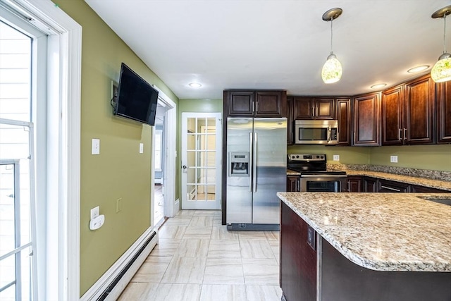 kitchen featuring pendant lighting, dark brown cabinets, kitchen peninsula, and appliances with stainless steel finishes