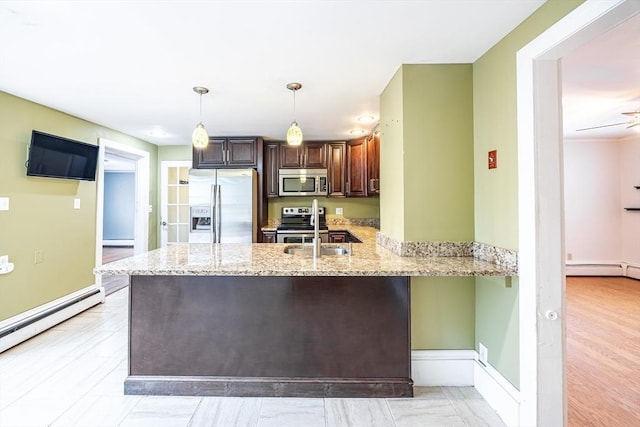 kitchen featuring sink, kitchen peninsula, pendant lighting, stainless steel appliances, and light stone counters