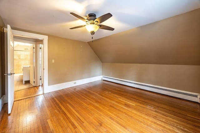 bonus room with ceiling fan, a baseboard radiator, light hardwood / wood-style flooring, and lofted ceiling