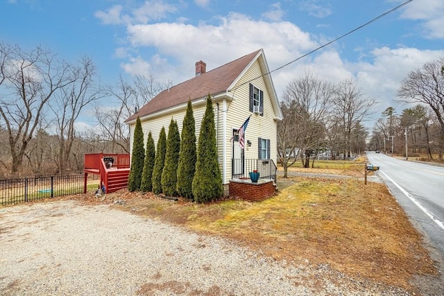 view of property exterior featuring a deck