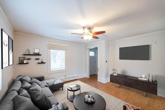 living room with light wood-type flooring, ceiling fan, ornamental molding, and a baseboard heating unit