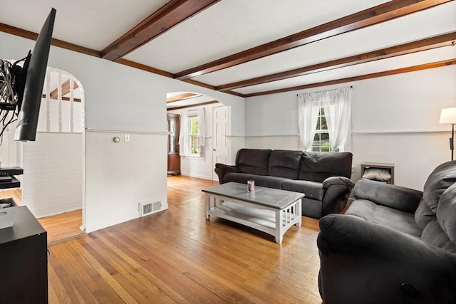 15 Dale St, Methuen, MA 01844 - living area with arched walkways, wood-type flooring, and beam ceiling