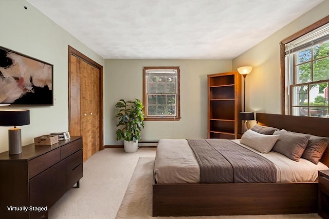 15 Dale St, Methuen, MA 01844 - bedroom with light carpet, baseboard heating, and a closet
