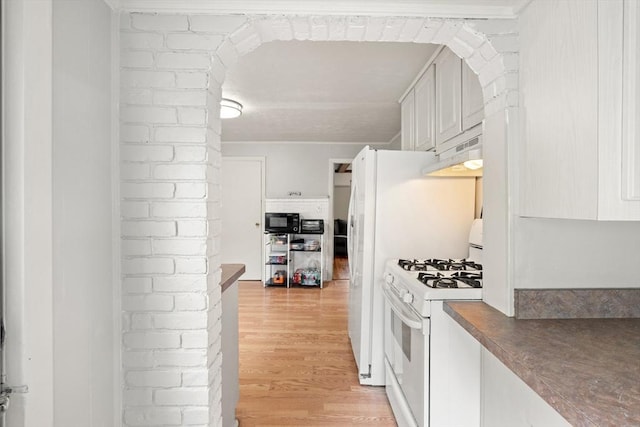 15 Dale St, Methuen, MA 01844 - kitchen with white gas range, black microwave, under cabinet range hood, light wood-type flooring, and arched walkways