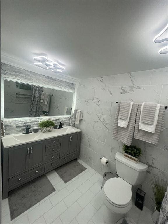 22 2nd Ave, Leominster, MA 01453 - bathroom featuring toilet, tile walls, and double vanity
