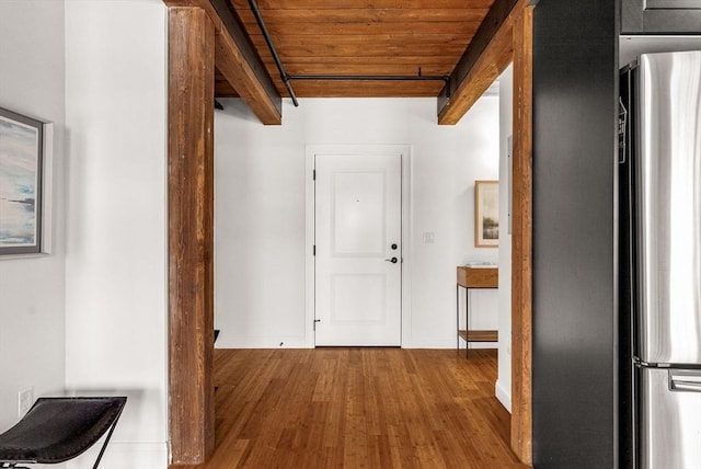 hall featuring wood ceiling, beam ceiling, and wood finished floors