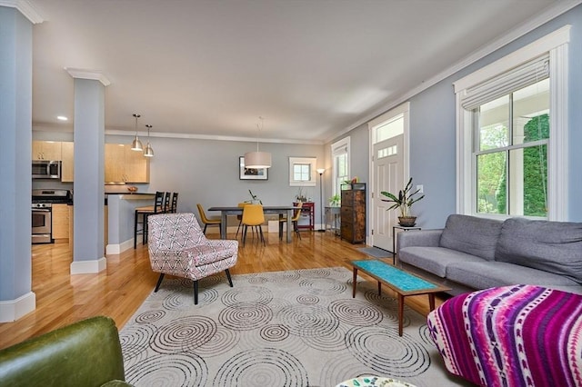 25 Union St Unit 2, Northampton, MA 01060 - living area featuring light wood-style flooring, crown molding, recessed lighting, baseboards, and decorative columns