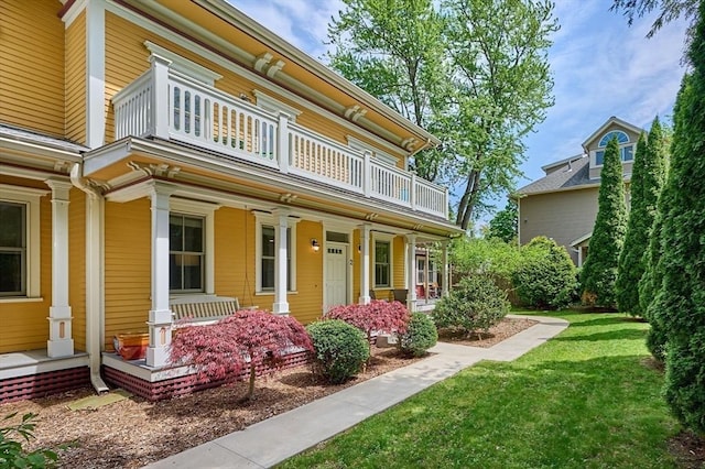 25 Union St Unit 2, Northampton, MA 01060 - view of front facade with a balcony, a porch, and a front lawn