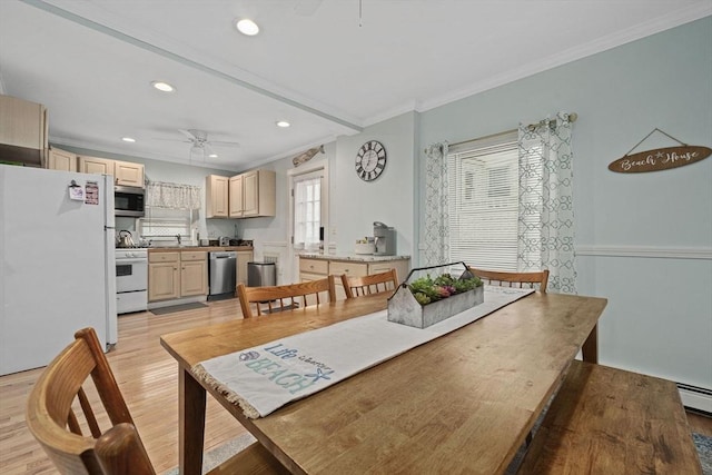 dining room with ceiling fan, ornamental molding, sink, and light hardwood / wood-style floors