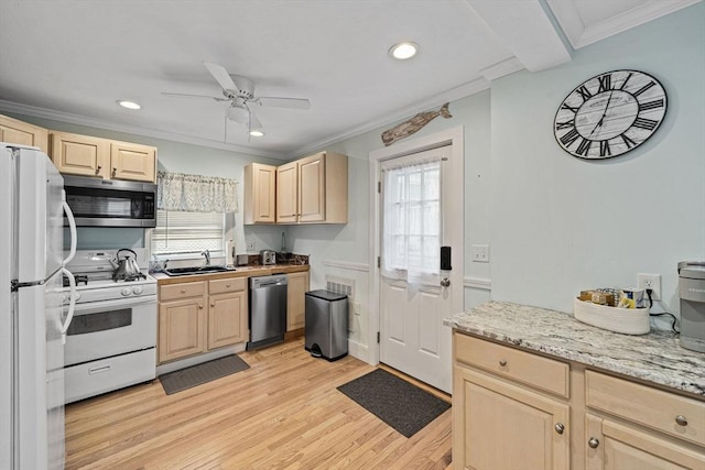 kitchen with sink, light wood-type flooring, light brown cabinets, ornamental molding, and stainless steel appliances