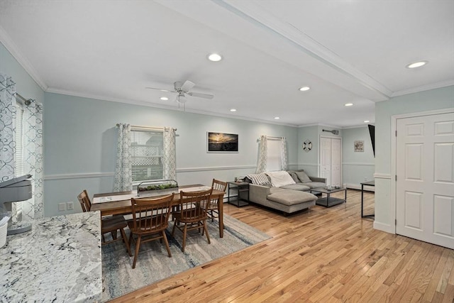 dining room featuring crown molding, ceiling fan, and light wood-type flooring