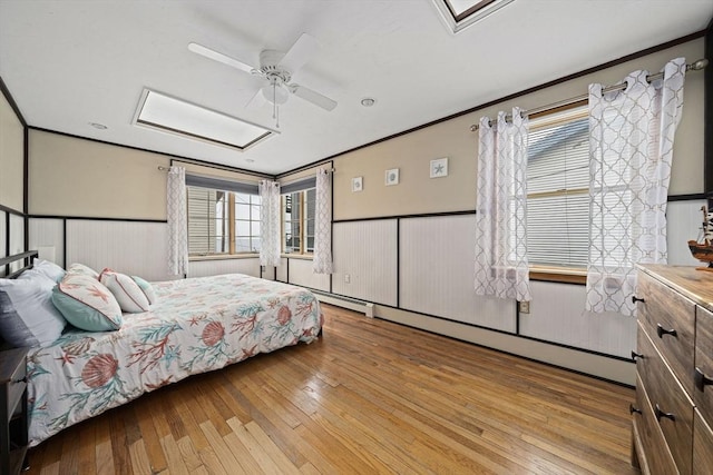 bedroom featuring crown molding, ceiling fan, and light wood-type flooring