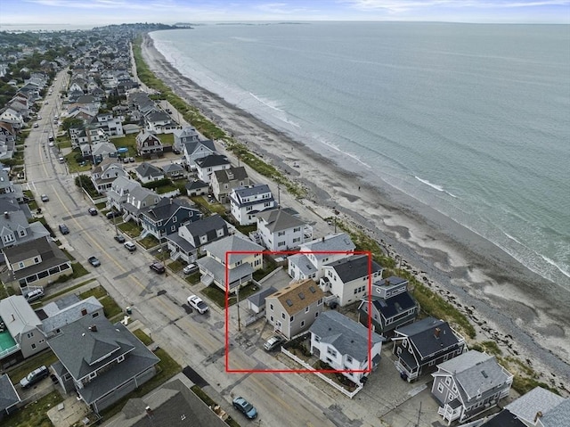 aerial view with a water view and a beach view