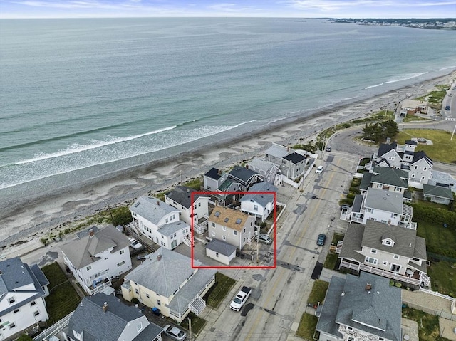 drone / aerial view featuring a water view and a beach view