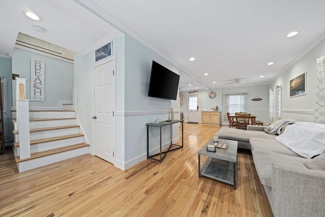 living room featuring crown molding, ceiling fan, and light hardwood / wood-style floors