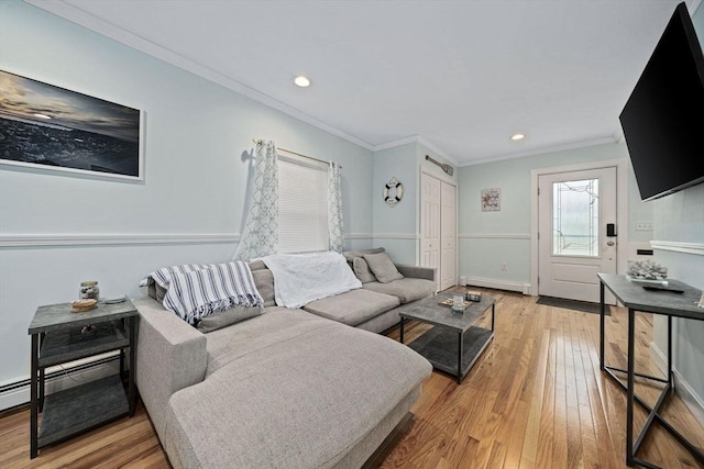 living room with hardwood / wood-style flooring, ornamental molding, and baseboard heating