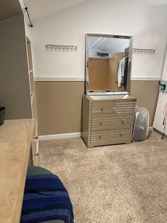 bedroom with carpet and lofted ceiling