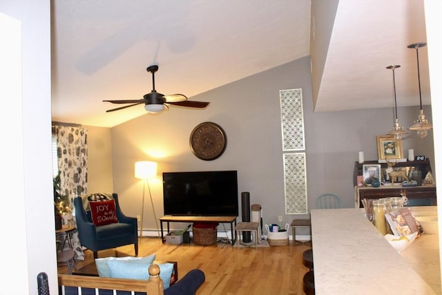 living room with hardwood / wood-style flooring, ceiling fan, a baseboard radiator, and vaulted ceiling