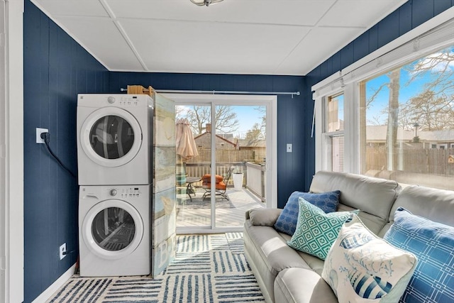 laundry area with stacked washer / dryer and laundry area