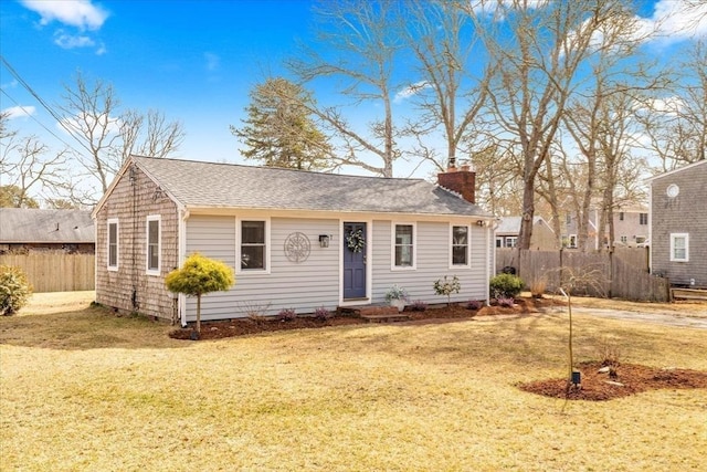 view of front of home with a front lawn, a chimney, a shingled roof, and fence