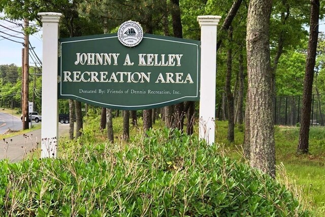 community sign featuring fence