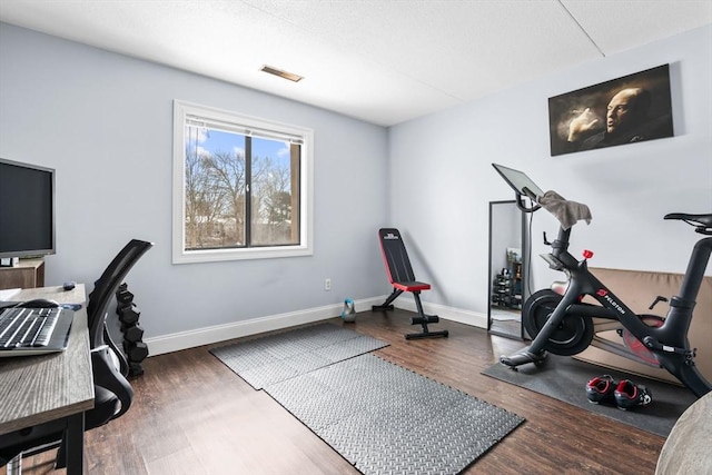 exercise room with dark hardwood / wood-style floors