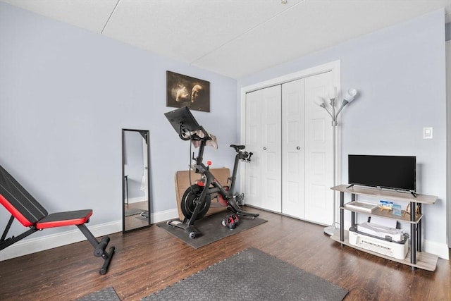 workout area with dark hardwood / wood-style floors