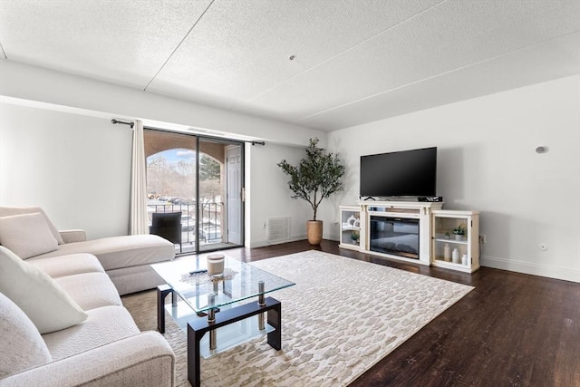 living room with hardwood / wood-style flooring and a textured ceiling