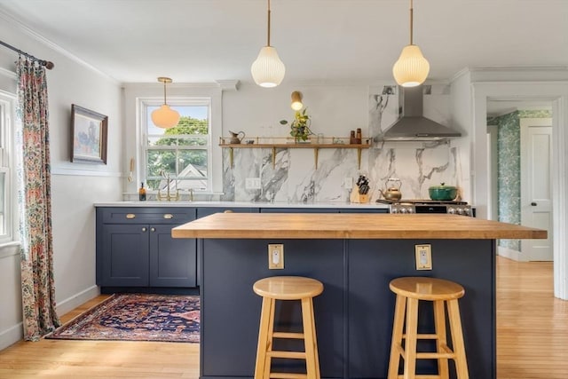 35 Ocean Ave Unit 3, Salem, MA 01970 - bar area with wall chimney exhaust hood, light wood-type flooring, decorative backsplash, decorative light fixtures, and stove