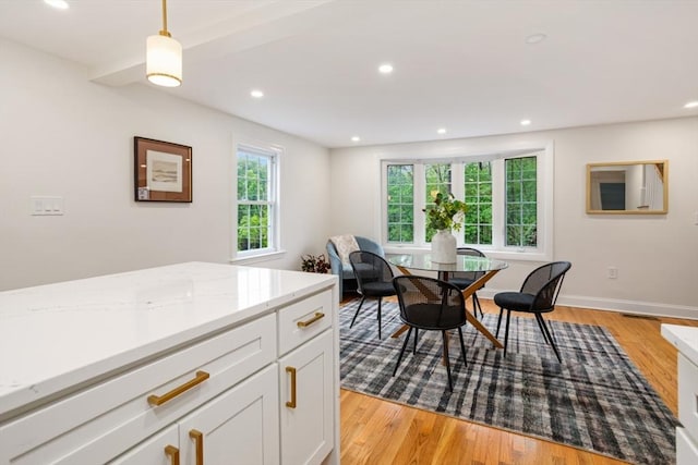 dining space featuring baseboards, light wood-type flooring, visible vents, and recessed lighting