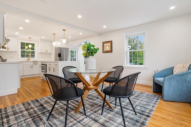 dining room featuring recessed lighting, baseboards, and light wood-style floors