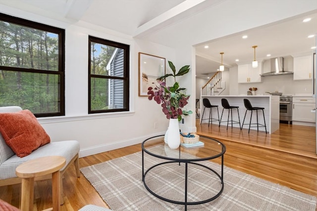 living room featuring baseboards, recessed lighting, stairway, and light wood-type flooring
