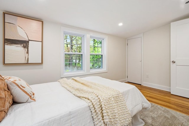 bedroom featuring baseboards, recessed lighting, and wood finished floors