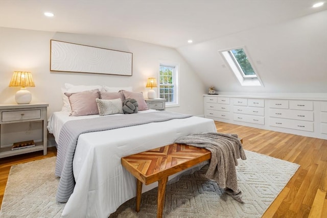bedroom with recessed lighting, light wood-type flooring, and vaulted ceiling with skylight