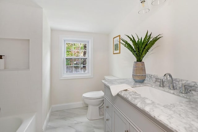 bathroom with vanity, toilet, baseboards, and marble finish floor