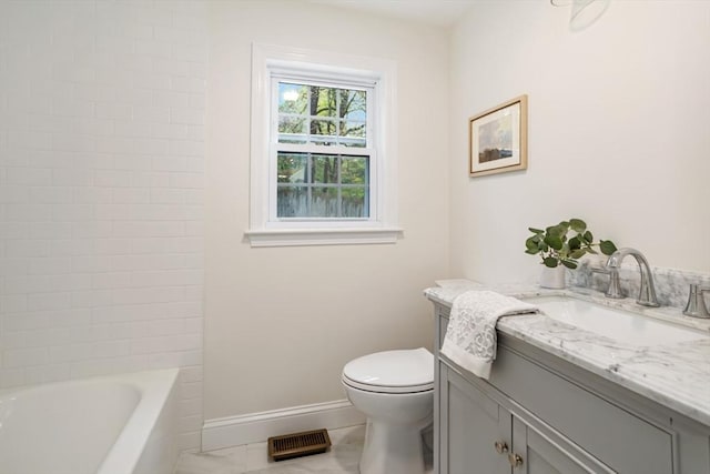 bathroom featuring toilet, marble finish floor, baseboards, and vanity