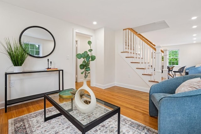 living area with stairway, recessed lighting, baseboards, and wood finished floors